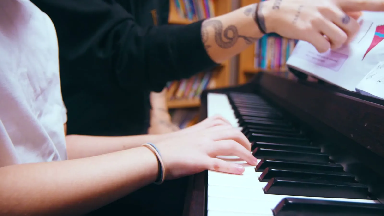 Close-up of a pupil’s hands on the piano keys.